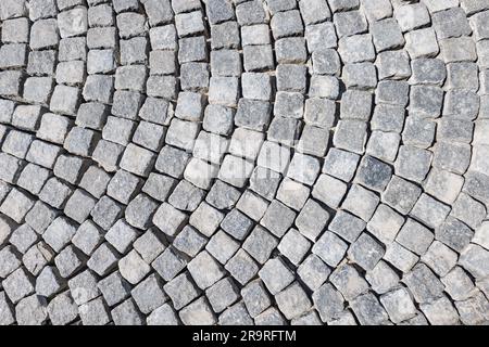 Old granite cobblestone road for texture or Top view of an old granite cobblestone road for texture or background Stock Photo