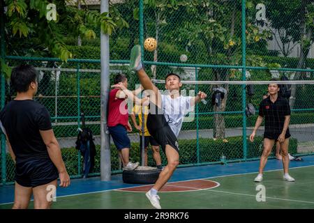 Bangkok, Thailand. 25th June, 2023. A Thai player of Sepak Takraw is seen performing an acrobatic figure during a game at Benchasiri Public Park Sukhumvit Road. Sepak Takraw also calledÂ kick volleyball or Thailand's Acrobatic Volleyball is one of Southeast Asia's most popular sports which is played with a ball made ofÂ rattanÂ or synthetic plastic where the players are only allowed to touch the ball with their feet, body, or head. (Credit Image: © Nathalie Jamois/SOPA Images via ZUMA Press Wire) EDITORIAL USAGE ONLY! Not for Commercial USAGE! Stock Photo