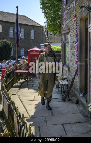 Haworth 1940's living history event (man patrolling & guarding, khaki WW2 Dad's Army costume, replica gas mask case kit) - West Yorkshire, England UK. Stock Photo