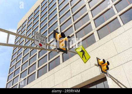 Low angle view of a pedestrian crosswalk traffic signal lights in a city Stock Photo