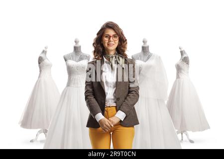 Young woman in casual work clothes in front of bridal dresses isolated on white background Stock Photo