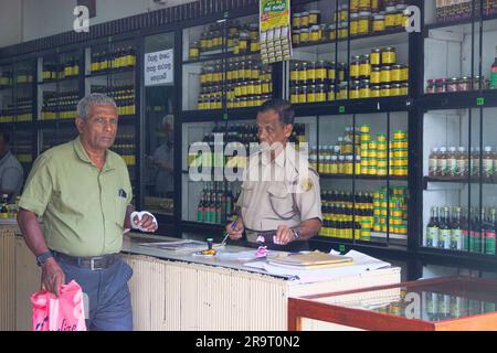 Sri Lanka, Kandy - January 13, 2020: Ayurvedic pharmacy. Apothecary in a special uniform and visitors. Stock Photo