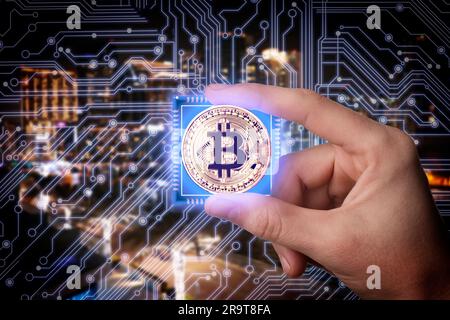 Man holding bitcoin against digital scheme and cityscape, closeup Stock Photo