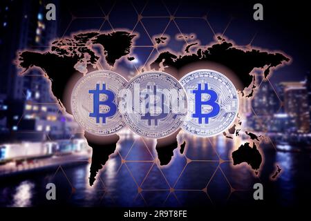 Cryptocurrency. Bitcoins and digital world map against blurred cityscape Stock Photo