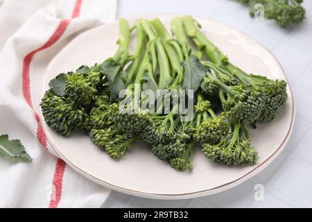 Fresh raw broccolini on white tiled table, closeup. Healthy food Stock Photo