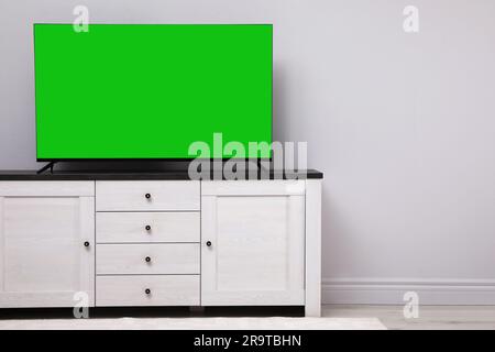 Chroma key compositing. TV with mockup green screen in room. Mockup for design Stock Photo