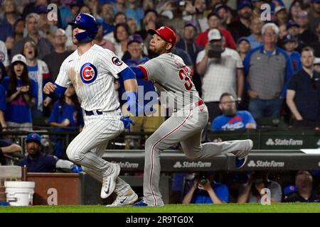 Chicago Cubs' Seiya Suzuki, left, is congratulated by first base coach Mike  Napoli after hitting a single against the San Francisco Giants during the  eighth inning of a baseball game in San