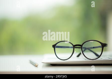 Object education green nature background with stack of ancient books or old bible, open paper book on wooden table with copy space. concept of back to Stock Photo