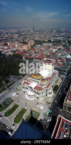 Aerial view of Mexico City skyline rising above the lush green canopy ...