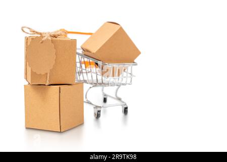 Cardboard boxes and shopping cart isolated on white background Stock Photo