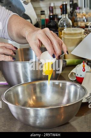 Chef beats in the yolk and white to make the cake. Stock Photo