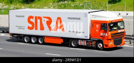 Side front view Sitra logo on DAF XF hgv lorry truck part of a supply chain transport logistics specialist business driving along m25 motorway road UK Stock Photo