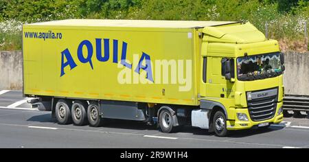 Aquila DAF XF semi truck a logistics business based in Romania decorated continental lorry driver cab windscreen & rigid trailer on M25 UK motorway Stock Photo