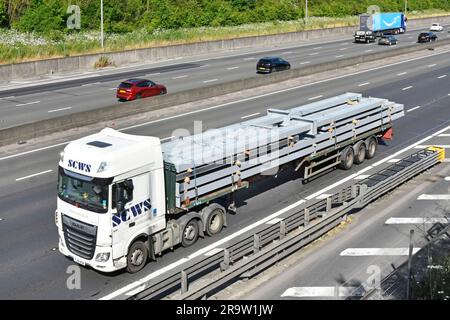 DAF XF 480 semi hgv lorry truck aerial view load primed fabricated structural steelwork on extended long articulated delivery trailer M25 motorway UK Stock Photo