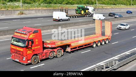 Volvo hgv semi lorry truck raised economy axle by Telescopic Heavy Haulage business low loader trailer traveling empty on M25 motorway road England UK Stock Photo