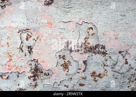 Dried cement, peeling red paint and rust spots on a cement mixer, soft focus close up, abstract texture Stock Photo