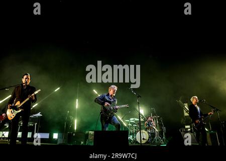 Roskilde, Denmark. 28th June, 2023. The American rock band Queens of the Stone Age performs a live concert during the Danish music festival Roskilde Festival 2023 in Roskilde. Here singer and musician Josh Homme is seen live on stage with guitarist Troy Van Leeuwen (L) and bass player Michael Shuman (R). (Photo Credit: Gonzales Photo/Alamy Live News Stock Photo