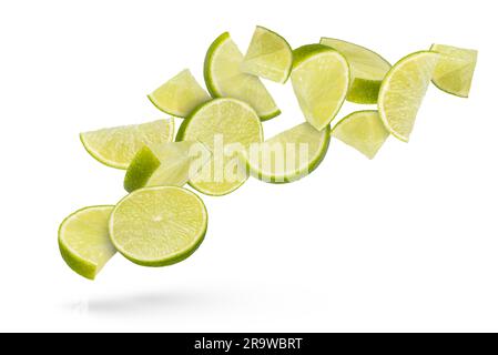 Flying fruits. Lime slices on a white isolated background. Lime slices scatter in different directions, casting a shadow, close-up. Suitable for Stock Photo