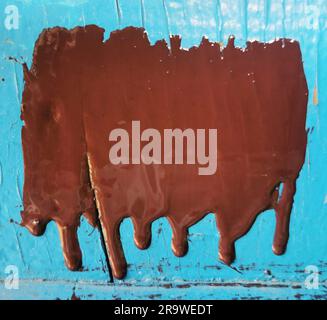 Paint drips on blue background Stock Photo