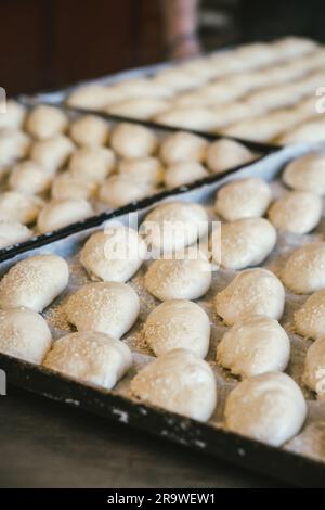 unbaked buns production of traditional sicilian food in an industrial bakery. Stock Photo