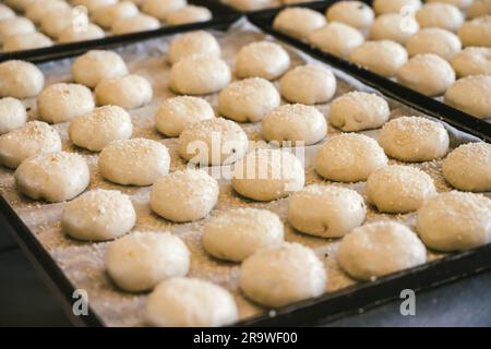 unbaked buns production of traditional sicilian food in an industrial bakery. Stock Photo