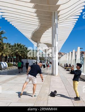 A street artist playing at the Promenade ( Paseo) Muelle Uno, Malaga, Spain Stock Photo