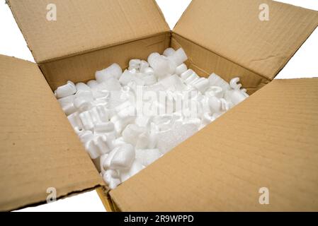 Fill packaging peanuts and bubble pack in a cardboard box, isolated on white background Stock Photo