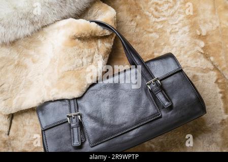 A black leather bag of warm blond sheepskin, blue fox and red sable mink furs Stock Photo