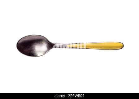 A metallic stainless inox coffee spoon with yellow handle isolated on white background Stock Photo