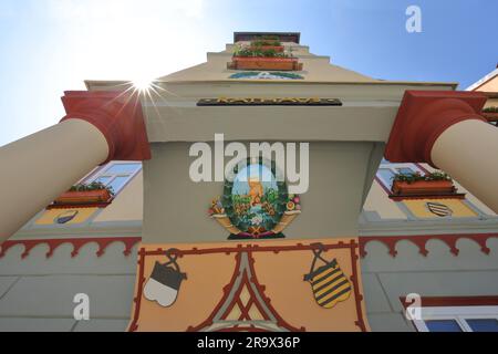 Facade with painting and ornaments of the town hall in backlight, view upwards, perspective, coat of arms, relief, Schleusingen, Thuringia, Germany Stock Photo