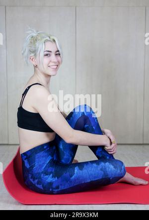 Portrait of beautiful young woman relaxing after doing exercise Stock Photo