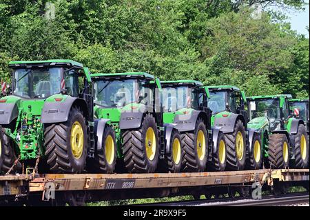 La Fox, Illinois, USA. Brand new tractors ride the rails forming part of the consist of an Union Pacific Railroad freight train. Stock Photo