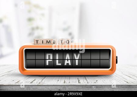 Time to play message on a retro alarm clock standing on a wooden table in a bright room Stock Photo