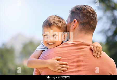 Happy, father and son hug, park and happiness with quality time, support and loving together. Outdoor, dad and male child with a smile, kid and parent Stock Photo