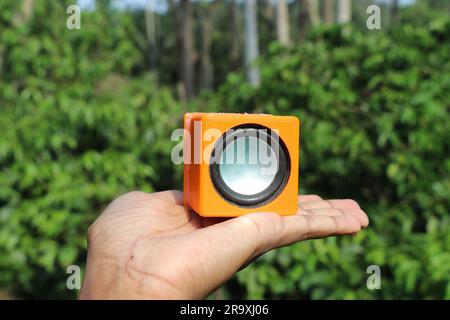 Outdoor Portable Wireless Bluetooth Speaker With Subwoofer Big hanging on  tree in the forest. Acoustic portable speaker camouflage color with yellow  c Stock Photo - Alamy