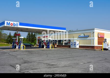 Watertown, NY, USA - May 22, 2023: Mobil Oil gas station with Quicklee's and Dunkin' Donuts. Quicklee’s is a convenience store chain in Upstate New Yo Stock Photo