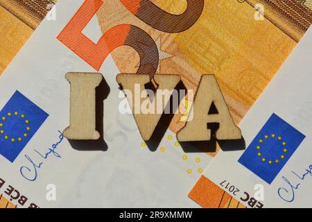 IVA in wooden alphabet letters isolated on Euro banknotes Stock Photo