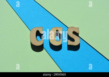 CCS abbreviation for Carbon Capture Storage in wooden alphabet letters isolated on blue and green background as banner headline Stock Photo