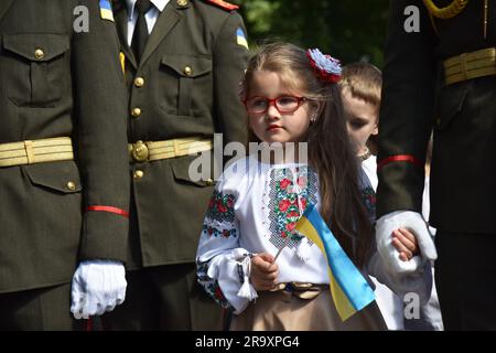 Children with Ukrainian flags during the celebration of the Constitution Day of Ukraine. Ukraine celebrated the 27th anniversary of the adoption of the country's basic law - the constitution. In the conditions of the Russian-Ukrainian war, official events were very short. In Lviv, the Ukrainian flag was raised, honor guard marched, and a military band performed. (Photo by Pavlo Palamarchuk / SOPA mages/Sipa USA) Stock Photo