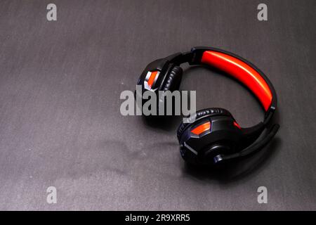 Wireless Over-Ear full size Headphones, Black leather isolated on black background with clipping path Stock Photo