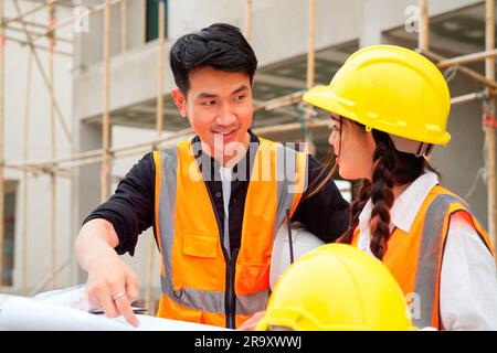 Civil engineers team with safety hard hat working together at construction site outdoor, Construction workers checking and controlling project on Stock Photo