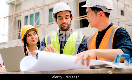 Civil engineers team with safety hard hat working together at construction site outdoor, Construction workers checking and controlling project on Stock Photo