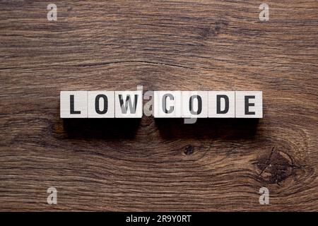 Low code - word concept on building blocks, text Stock Photo