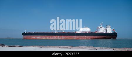 PORT ARANSAS, TX - 26 FEB 2023: Starboard view of the PROTEUS BOHEMIAN, an Oil Tanker Ship sailing in from the Gulf of Mexico by a rock jetty on the s Stock Photo