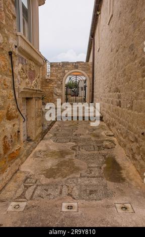 Supetar,Croatia-May 13 2023. Remnants of C6th early Christian mosaics in Supetar on Brac Island. Mother Teresa Monument is in the background Stock Photo