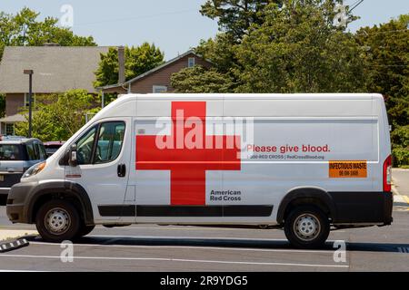 Cape May Court House, NJ - May 25, 2023: American Red Cross vehicle with 'Please give blood.' on the side and infectious waste sign Stock Photo