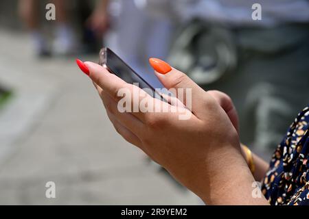 Woman holding smart phone in hands Stock Photo