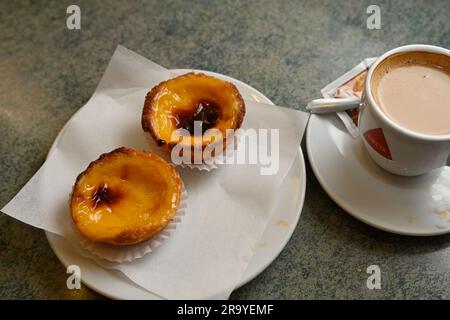 Two traditional Portuguese egg tart pastry, Pastel de Nata, with cup of coffee Stock Photo