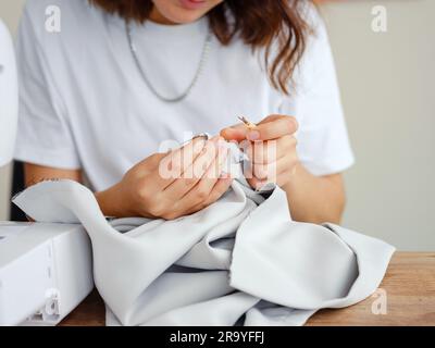 Fashion, fabric and sewing, woman at machine in small business with creative ideas and focus at home studio. Creativity, startup and design, tailor or Stock Photo