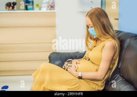 young woman in the waiting room interview sitting on sofa in corridor of dentist office or reception modern medical center while doctor's appointment Stock Photo